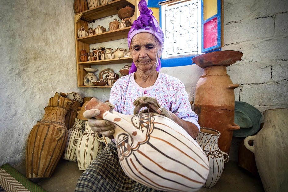 Moroccan potter Aicha Tabiz, also known as Mama Aicha, holds one of her works near the village of Ourtzagh in the foothills of the Rif mountains. Like everywhere in the Rif mountains, women potters from the Sless tribe, to which Aicha Tabiz's family belongs, are vanishing. The tribe counted around 90 potters at the end of 1990s. Now, only a half-dozen remain. PHOTO: Reuters.
