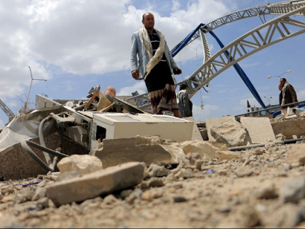 Men inspect a damaged petrol station after it was hit by a previous alleged Saudi-led coalition airstrike on the outskirts the Yemeni capital Sanaa on May 21, 2018. PHOTO: AFP