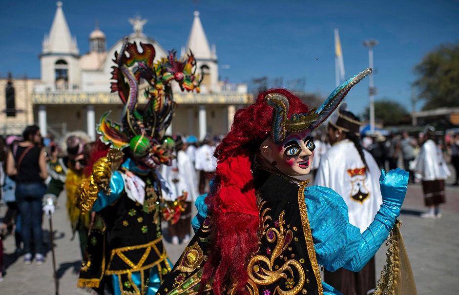 Dancers in traditional costumes perform during 