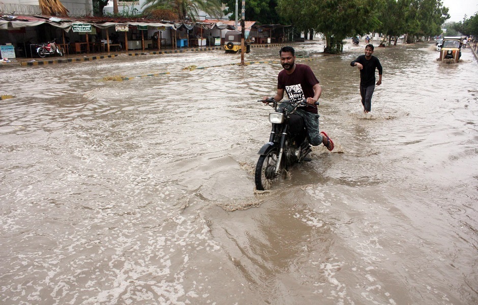 This man on the motorcycle faces trouble due to the heavy rainfall in Karachi. PHOTO: APP