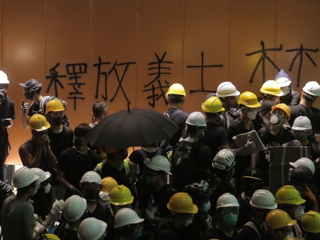 graffiti is seen on a wall of the government headquarters after protesters broke into the building in hong kong on july 1 2019 photo afp