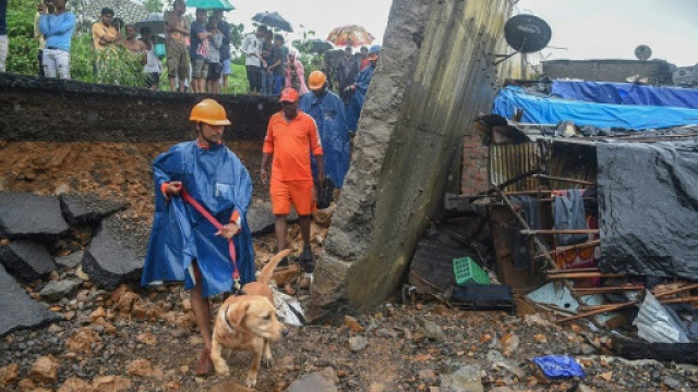 the death toll from a wall collapse in a mumbai slum rose to 26 as the city braced for more rain photo afp