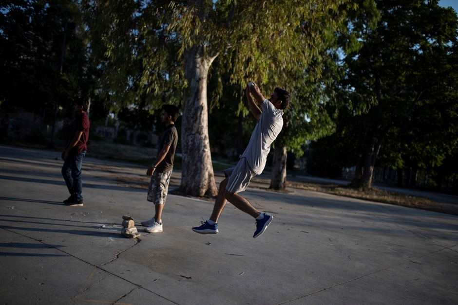 a pakistani man living in greece bawls a ball during a tape ball cricket game in a parking lot in the tavros neighbourhood in athens greece june 29 2019 picture taken june 29 2019 photo reuters