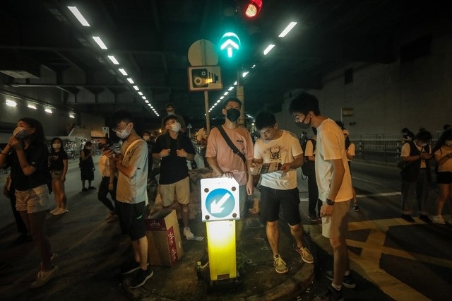 protesters block a road while taking part in a demonstration in the north western district of tuen mun in hong kong on july 6 2019 as confrontations between police and people against a proposed extradition bill continue   sparked by a law that would have allowed extraditions to mainland china the city has witnessed three huge peaceful rallies as well as civil disobedience and violence from a hard core of younger protesters who have besieged the police headquarters and on monday stormed the city 039 s parliament photo afp file