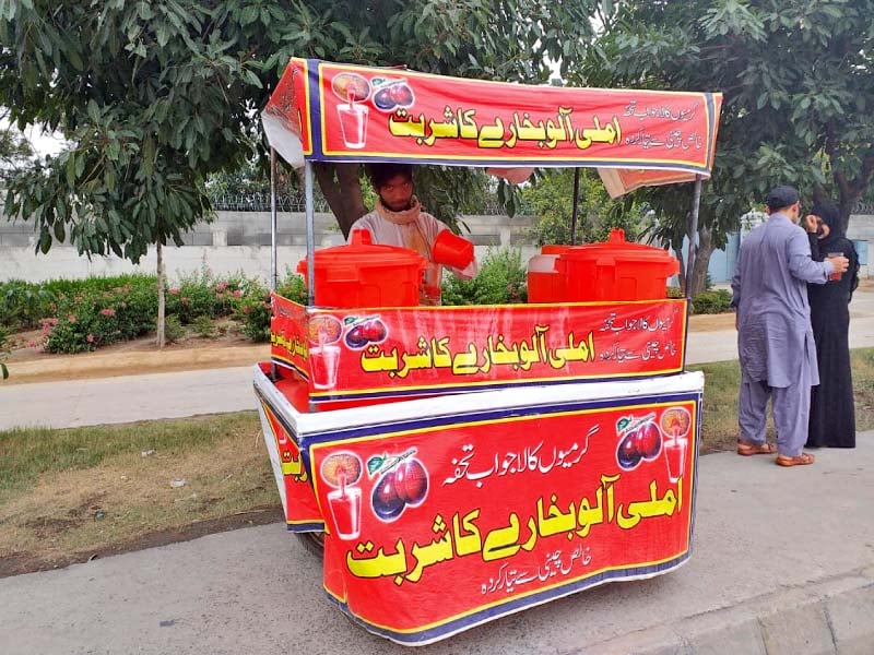 a man sells tamarind plum juice on a roadside in rawalpindi photo express