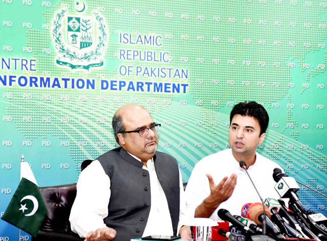 special assistant to the prime minister on accountability shahzad akbar with minister for communications and postal services murad saeed in a press conference in islamabad on monday photo pid