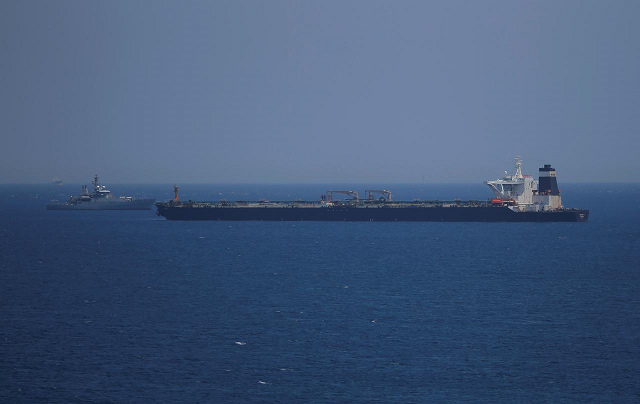 a british royal navy patrol vessel guards the oil supertanker photo reuters