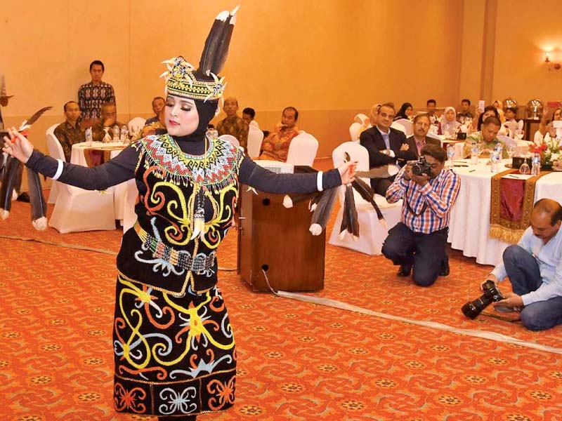 an indonesian performer presents traditional dance dna