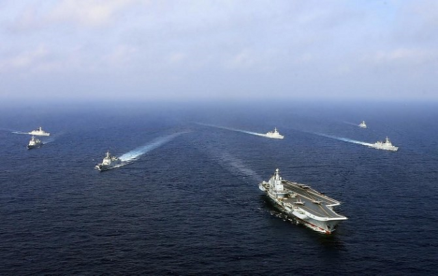 above the liaoning china s sole operational aircraft carrier sails with other ships during a drill at sea in this april 2018 photo afp