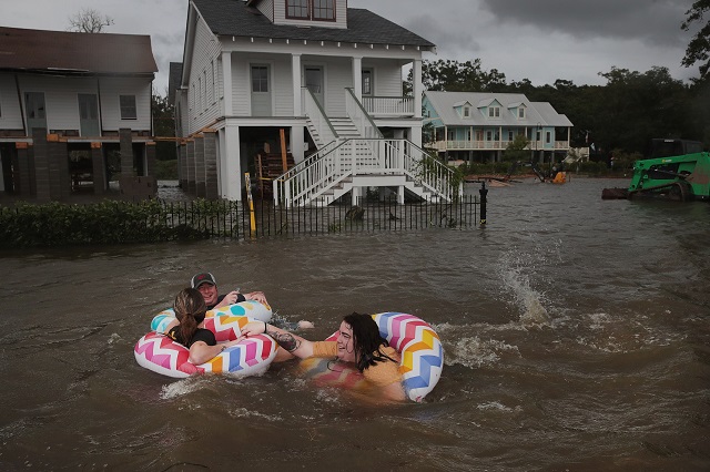 mandeville louisiana people float down lakeshore drive which is covered by water from lake pontchartrain after the area flooded in the wake of hurricane barry afp
