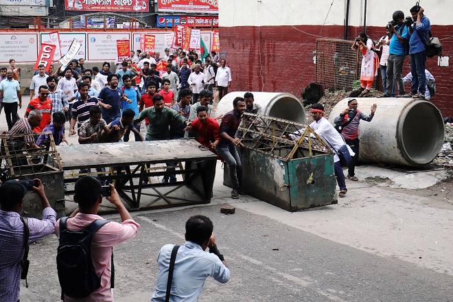 people cross a barricade near the ministry of power energy and mineral resources as they protest against hike in natural gas price photo reuters