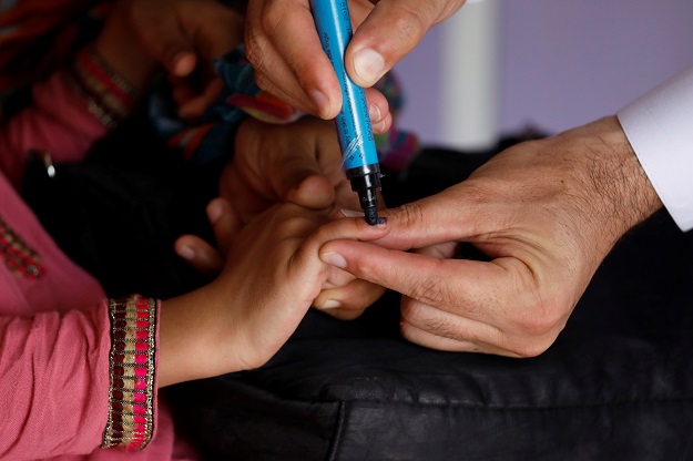 a girl gets her finger marked after she is administered polio vaccine drops at a civil dispensary in peshawar on july 11 2019 photo reuters