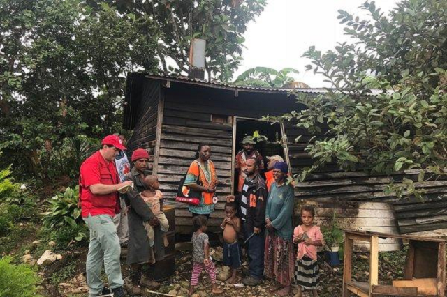 papuans outside a damaged house at kar in papua new guinea photo afp file