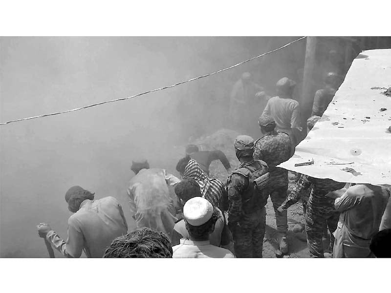 locals and rescue officials work to pull bodies of eight people who were buried when the roof of a house collapsed in orakzai tribal district photo online