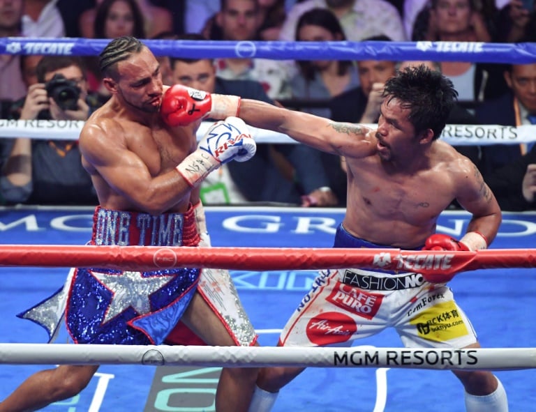 40 year old pacquiao downs thurman to capture wba crown