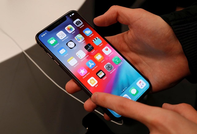 a customer tests a smartphone during the launch of the new iphone xs and xs max sales at quot re store quot apple reseller shop in moscow russia september 28 2018 photo reuters