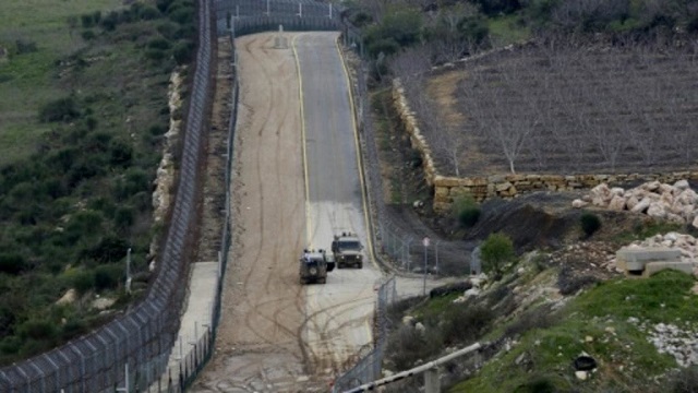 the fence separating the israeli annexed golan heights from syria is patrolled by israeli military vehicles photo afp