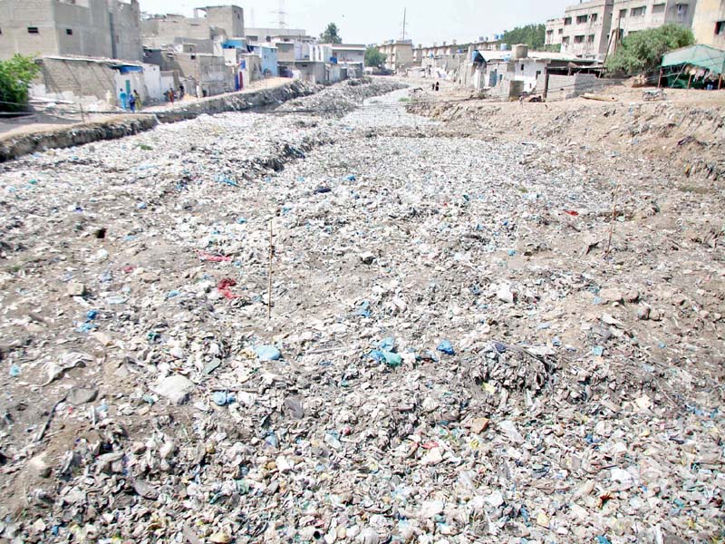 several of karachi s drains remain clogged despite efforts initiated supposedly in time for the monsoon the accumulation of waste dumped by citizens govt and private institutions is causing the storm water drains to choke all over the city says one kmc official photos nni