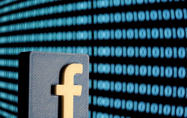 a 3 d printed facebook logo is seen in front of displayed binary code in this illustration picture june 18 2019 photo reuters