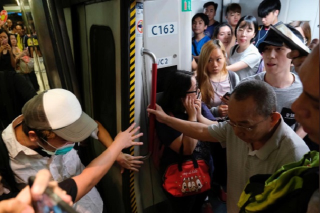 activists blocked train doors playing havoc with services and forcing hundreds of people to stream out of railway stations in search of alternative transport photo reuters