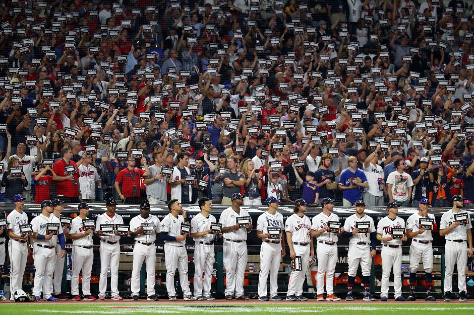 Fans and players hold Stand Up to Cancer signs during the 2019 MLB All-Star Game:AFP