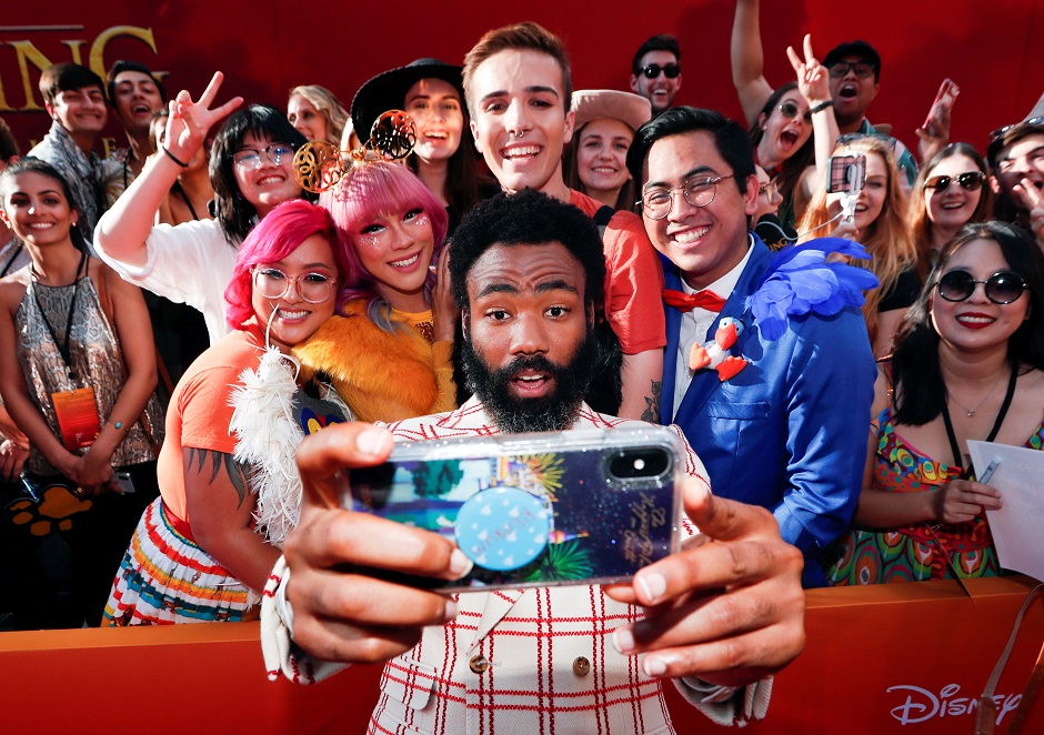 Cast member Donald Glover poses for a photo with fans during the World Premiere of 