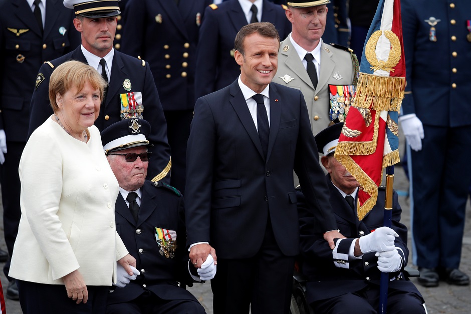German Chancellor Angela Merkel and French President Emmanuel Macron attend the traditional Bastille Day military parade: REUTERS