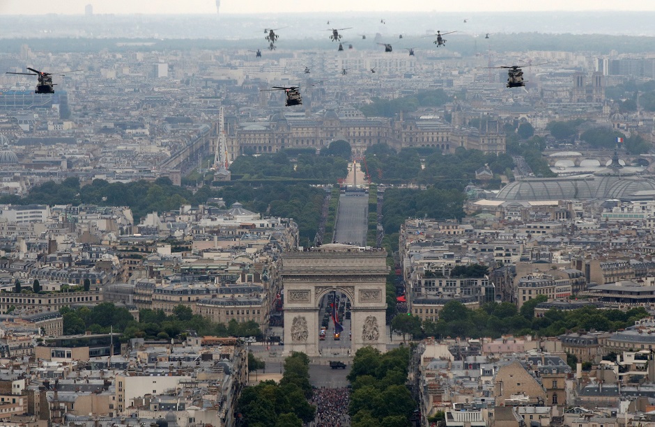 Helicopters fly over the Champs-Elysees Avenue and the Arc de Triomphe during the traditional Bastille Day military parade in Paris: REUTERS