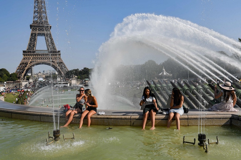 People cool off at the Trocadero Fountains next to the Eiffel Tower in Paris, as a new heatwave hits Europe. PHOTO: AFP