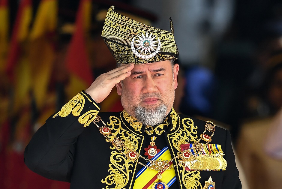 , Malaysia's Sultan Muhammad V salutes the royal guard of honour during the opening ceremony of the parliament in Kuala Lumpur. PHOTO: AFP