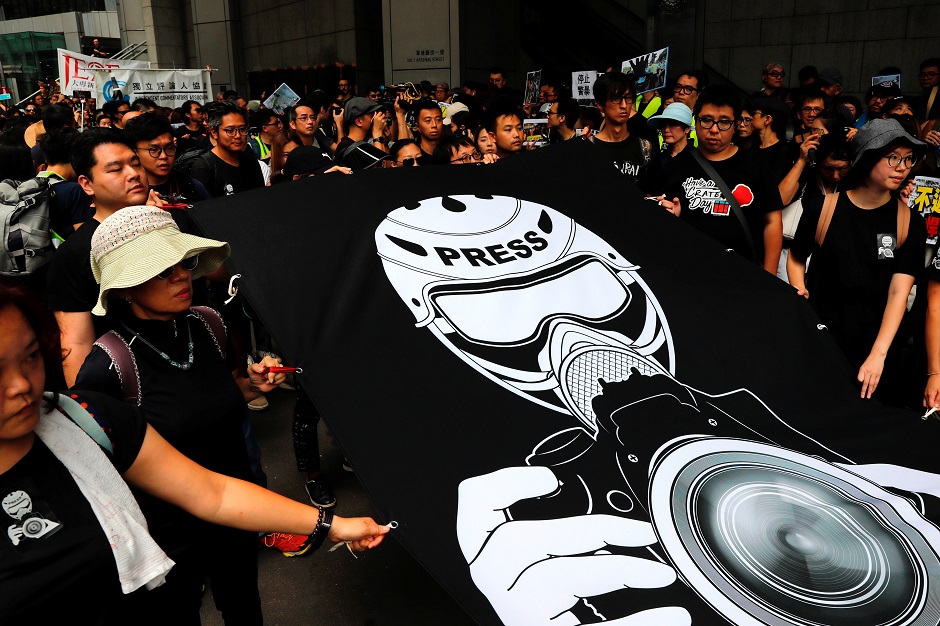 Journalists and supporters for press freedom wear black as they stage a silent march to Police Headquarters to denounce media treatment during protest against a proposed extradition bill, in Hong Kong. PHOTO: Reuters