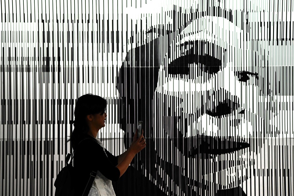 A visitor takes a photo of an art work entitled 'Anxiety' during a 