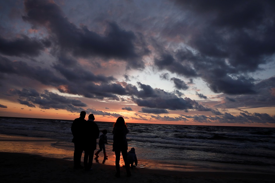 5.People stand at the beach during sunset at the Polish Baltic Sea coast near Choczewo, Poland. PHOTO: Reuters.