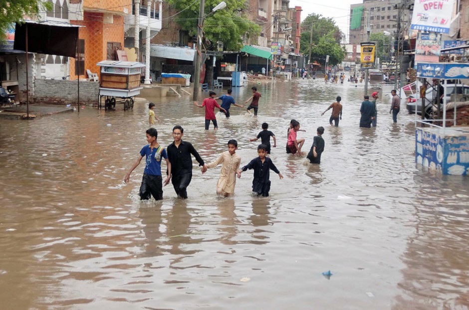 Children play in the rain water on the streets of Hyderabad. PHOTO: APP