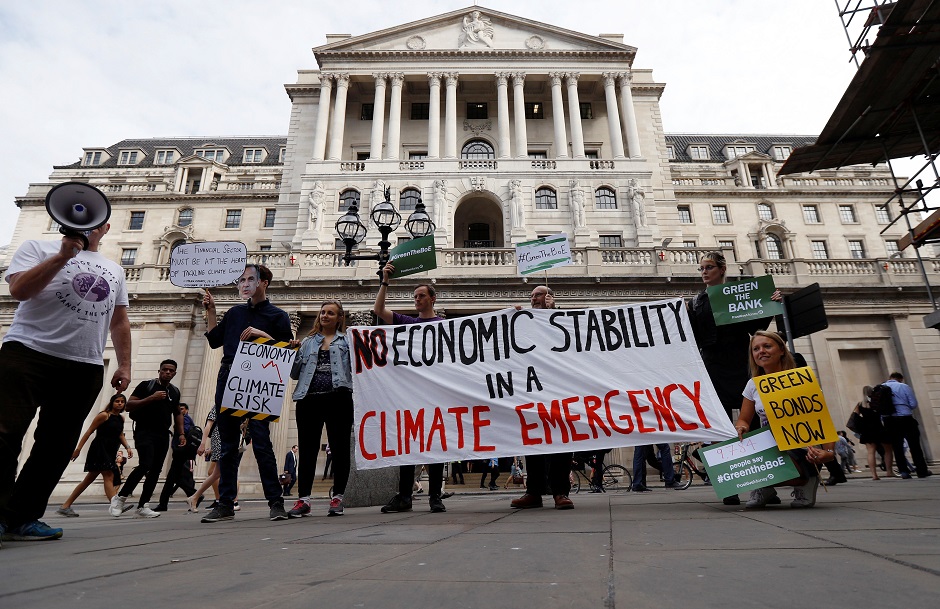 Environmental and banking system protestors demonstrate outside the Bank of England demanding that the bank rule out investment in high-carbon sectors in London. PHOTO: Reuters.