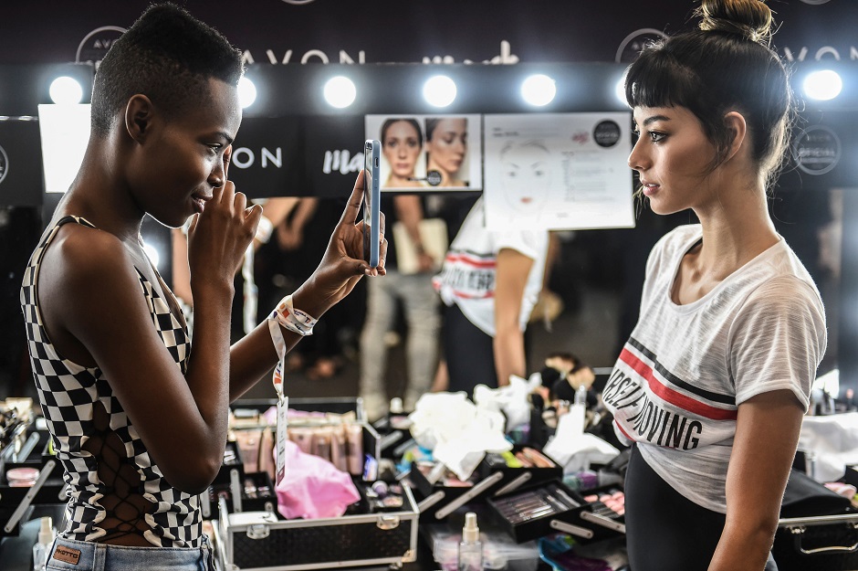 Models photograph each other backstage at Colombiamoda during Medellin's fashion week in Medellin, Antioquia's department, Colombia. PHOTO: AFP