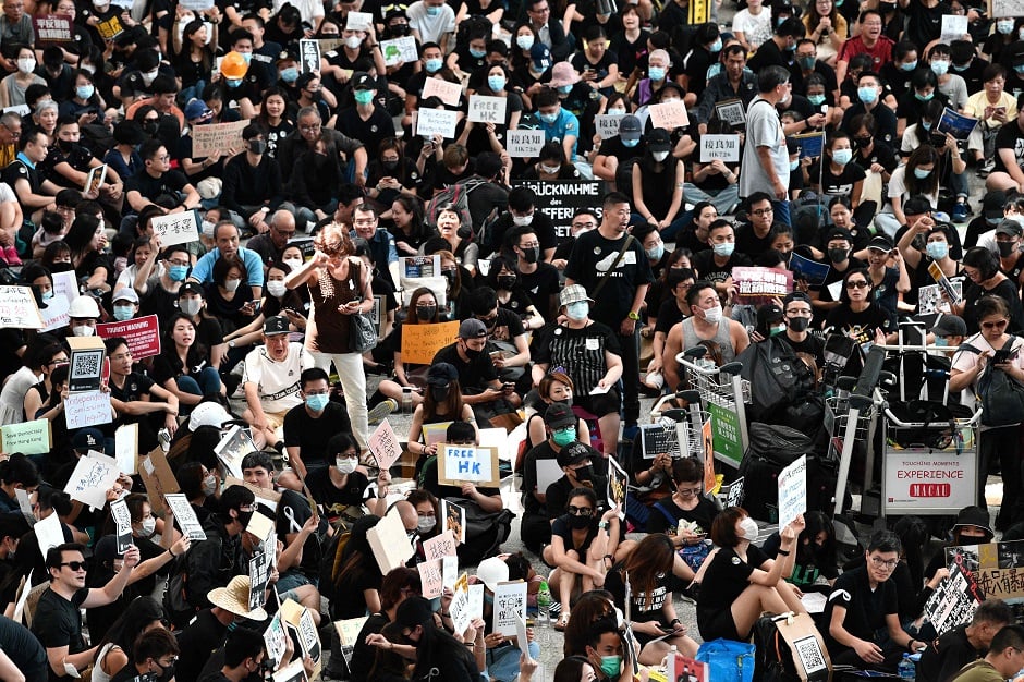 Protesters rally against a controversial extradition bill in the arrivals hall at the international airport in Hong Kong. PHOTO: AFP