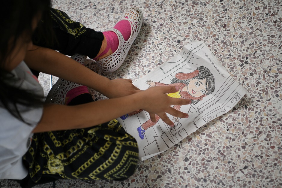 Alicia, a five-year-old migrant girl from Guatemala, colours while waiting with her mother and fellow Central American asylum seekers recently released from federal detention, at a bus depot in McAllen, Texas. PHOTO: Reuters