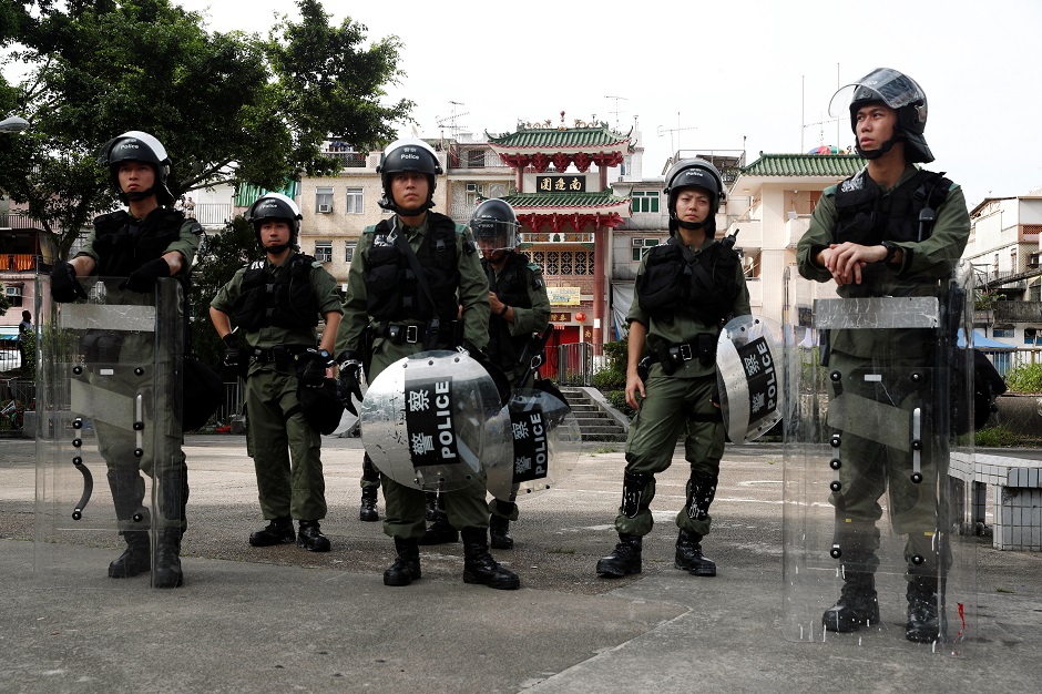  Police officers stand guard outside Nam Pin Wai village during a protest against the Yuen Long attacks in Yuen Long, New Territories, Hong Kong, China. PHOTO: Reuters 