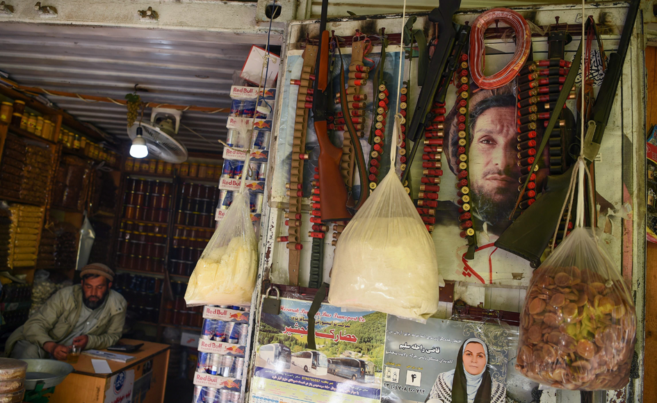 A shopkeeper looks on in his store with posters bearing the image of Ahmad Shah Massoud,  in Tawakh in Panjshir Province, north of the capital Kabul. Photo: AFP