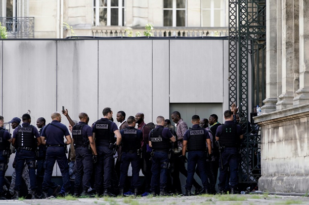After demonstrating for several hours, the migrants were escorted calmly out of a back entrance. PHOTO: AFP