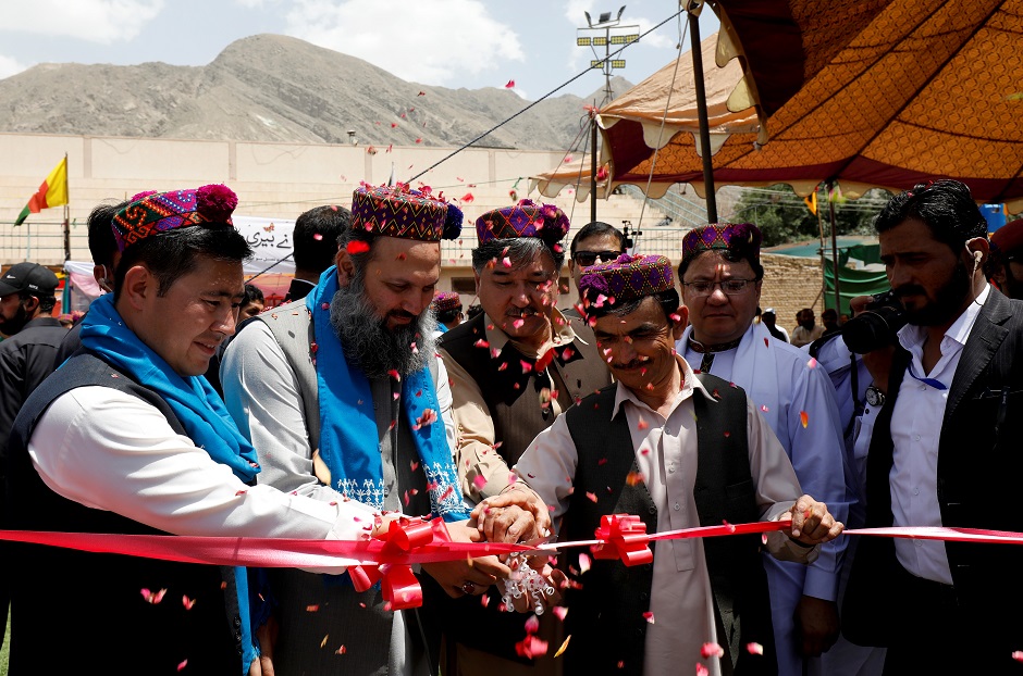 CM Baluchistan Jam Kamal Khan (2nd L), along with the chairman of HDP Abdul Khaliq Hazara (3rd L) and others wear traditional Hazargi caps, as they cut the ribbon to begin Hazara Culture Day PHOTO: Reuters