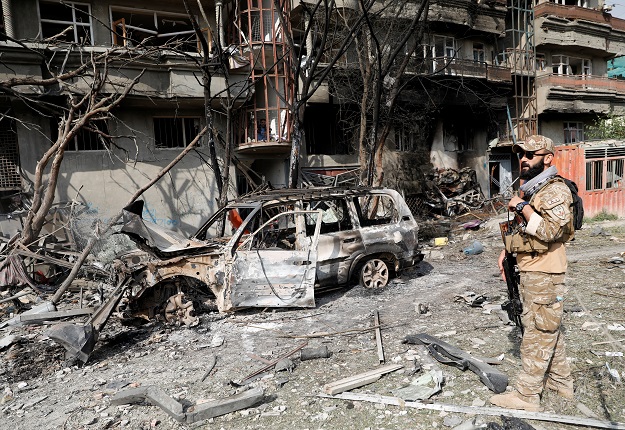 An Afghan security force personnel inspects the site of Sunday's attack in Kabul. PHOTO: REUTERS
