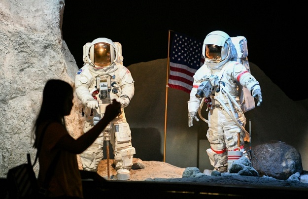 A visitor looks at a lunar landscape exhibit during the Apollo 11, 50th Live celebration at Space Center Houston in Houston, Texas . PHOTO: AFP