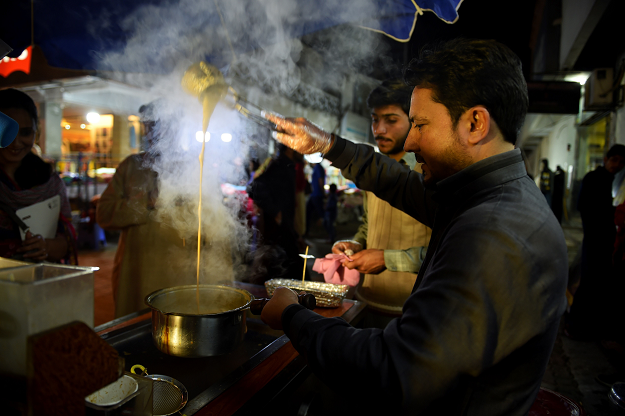 In this picture taken on March 29, 2019, a Pakistani worker prepares tandoori tea at a stall of a market in Islamabad. PHOTO: AFP