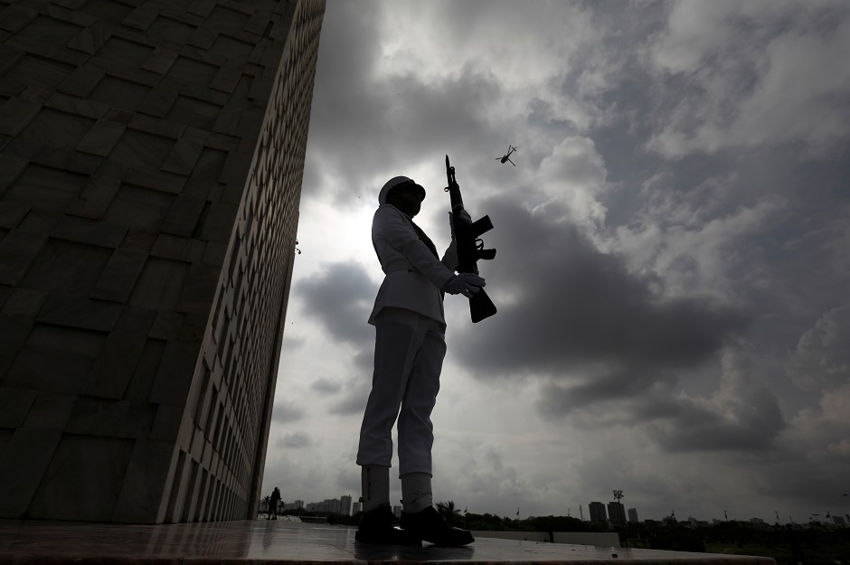 A cadet of the Pakistan Navy, positions with the backdrop of monsoon clouds during a ceremony at the Mausoleum of Muhammad Ali Jinnah. (Photo: Akhtar Soomro / REUTERS)