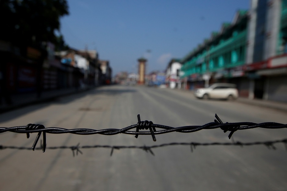 Barbed wire is seen laid on a deserted road during restrictions in Srinagar. (Photo: REUTERS/Danish Ismail)
