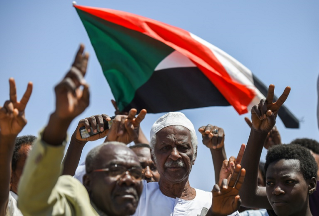 the jubilant crowds waved the sudanese flag chanting quot civilian civilian quot and women were ululating as cars driving honked their car horns photo afp