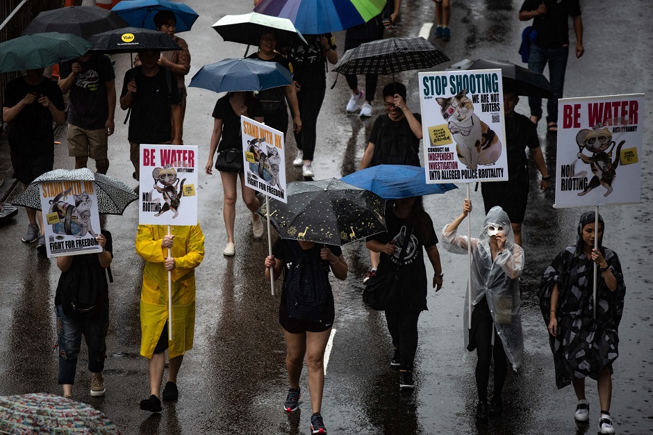 Protesters walk along a street during a rally in Hong Kong. PHOTO: AFP