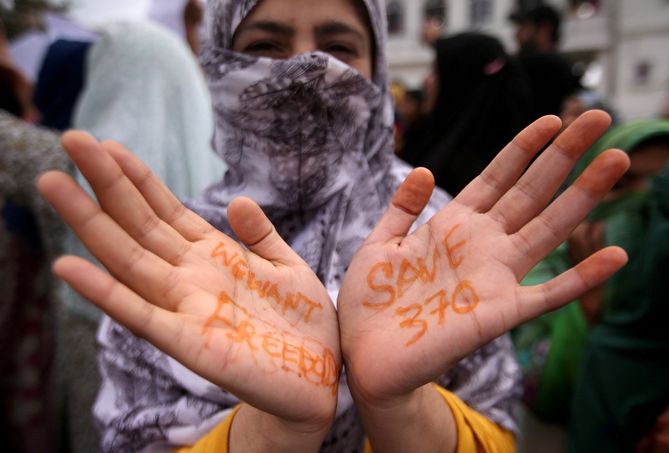  A Kashmiri woman shows her hands with messages at a protest. PHOTO: REUTERS 